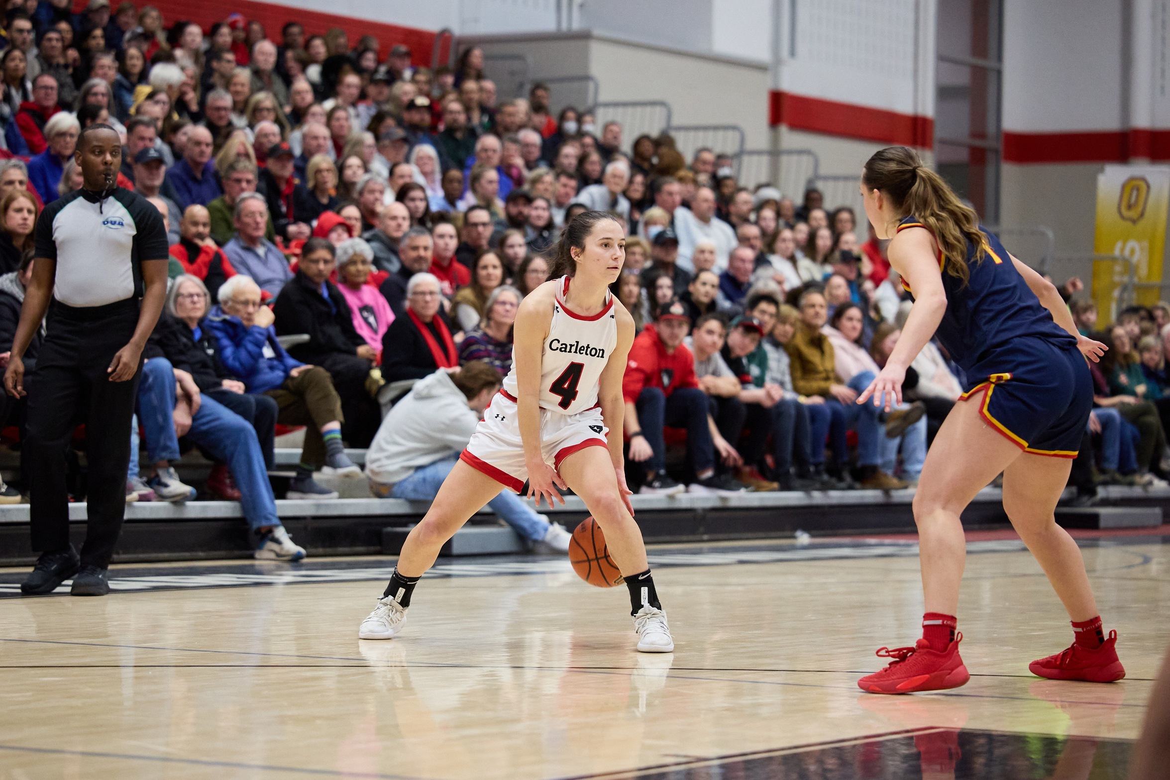 An action photo of Carleton Ravens Basketball athlete Kali Pocrnic on the court. 