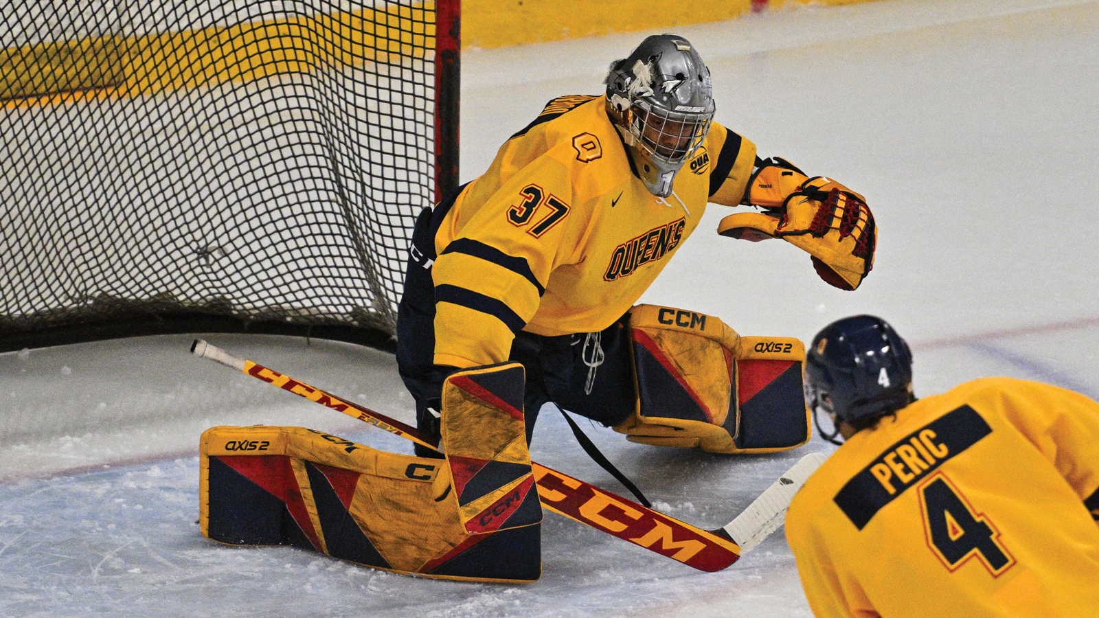 Queen's men's hockey goalie making a save