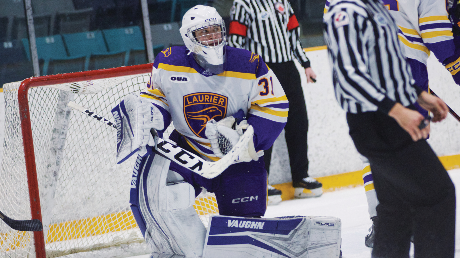 Laurier men's hockey goalie standing up on the ice after making a save