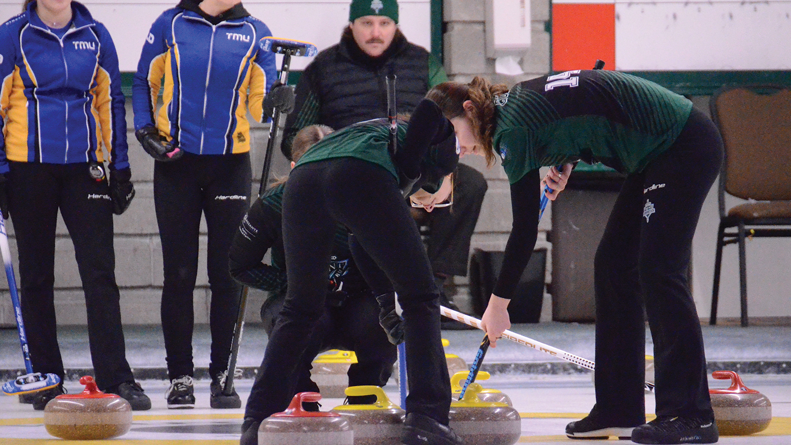 Action photo of the Trent Excalibur women's curling team  