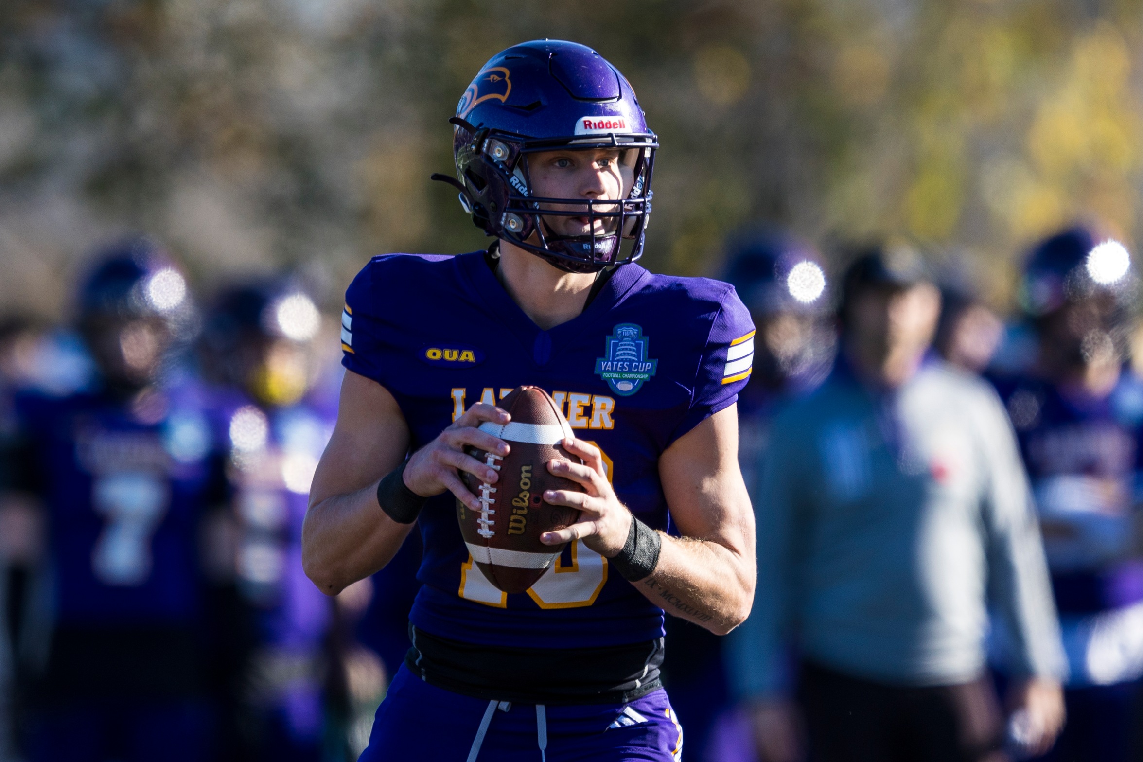 Action photo of Laurier quarterback about the throw the football 
